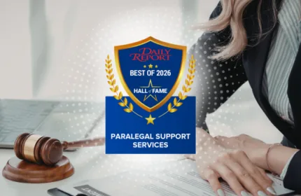 Beacon Hill Legal 2026 Best of the Daily Report Hall of Fame award badge for paralegal support services displayed over a desk with a gavel, laptop, and person reviewing documents