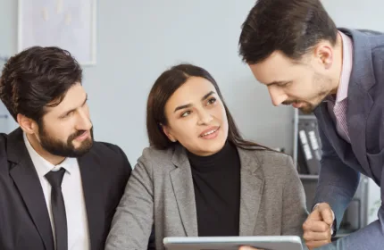 Professionals reviewing plans in an office, representing commercial project consulting and support.