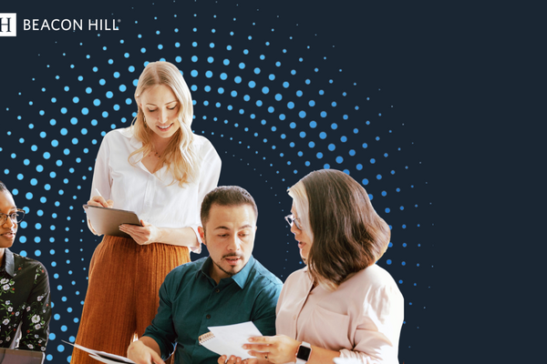 Team of professionals reviewing documents and collaborating on workforce planning strategies against a digital data background